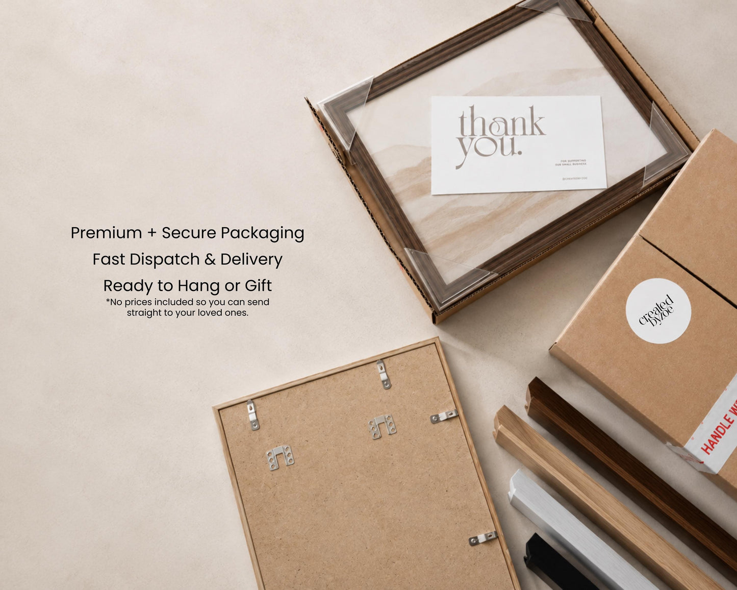 a framed picture, a note, and some cardboard boxes, all placed on a table.